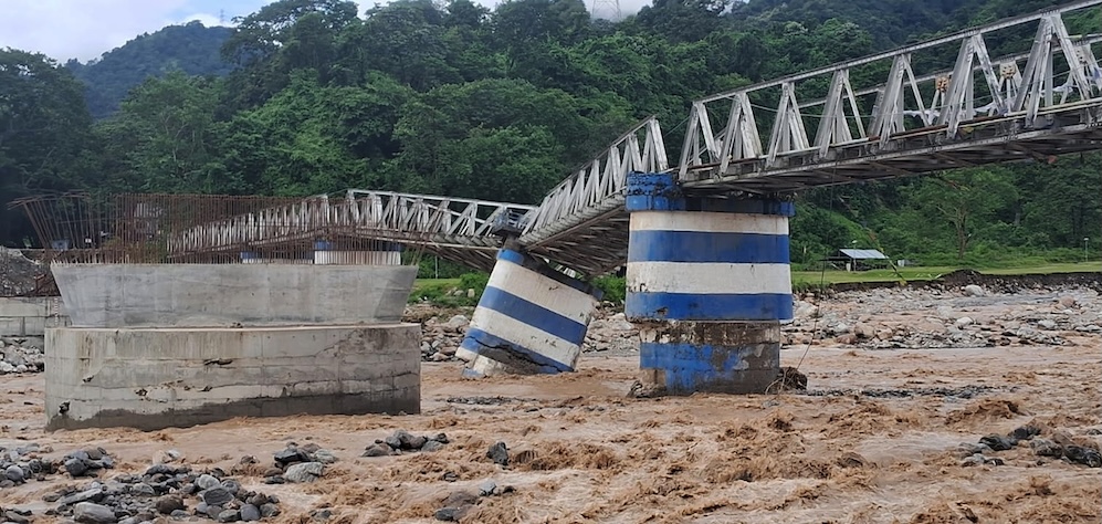 A washed away portion of Dudhiya bridge is pictured at Dudhiya village on the outskirts of Siliguri. Heavy rain and landslides killed at least 15 villagers in nearby hill areas in Mirik and Kalimpong, Darjeeling hills causing several landslides also blocks the road traffic on Sunday